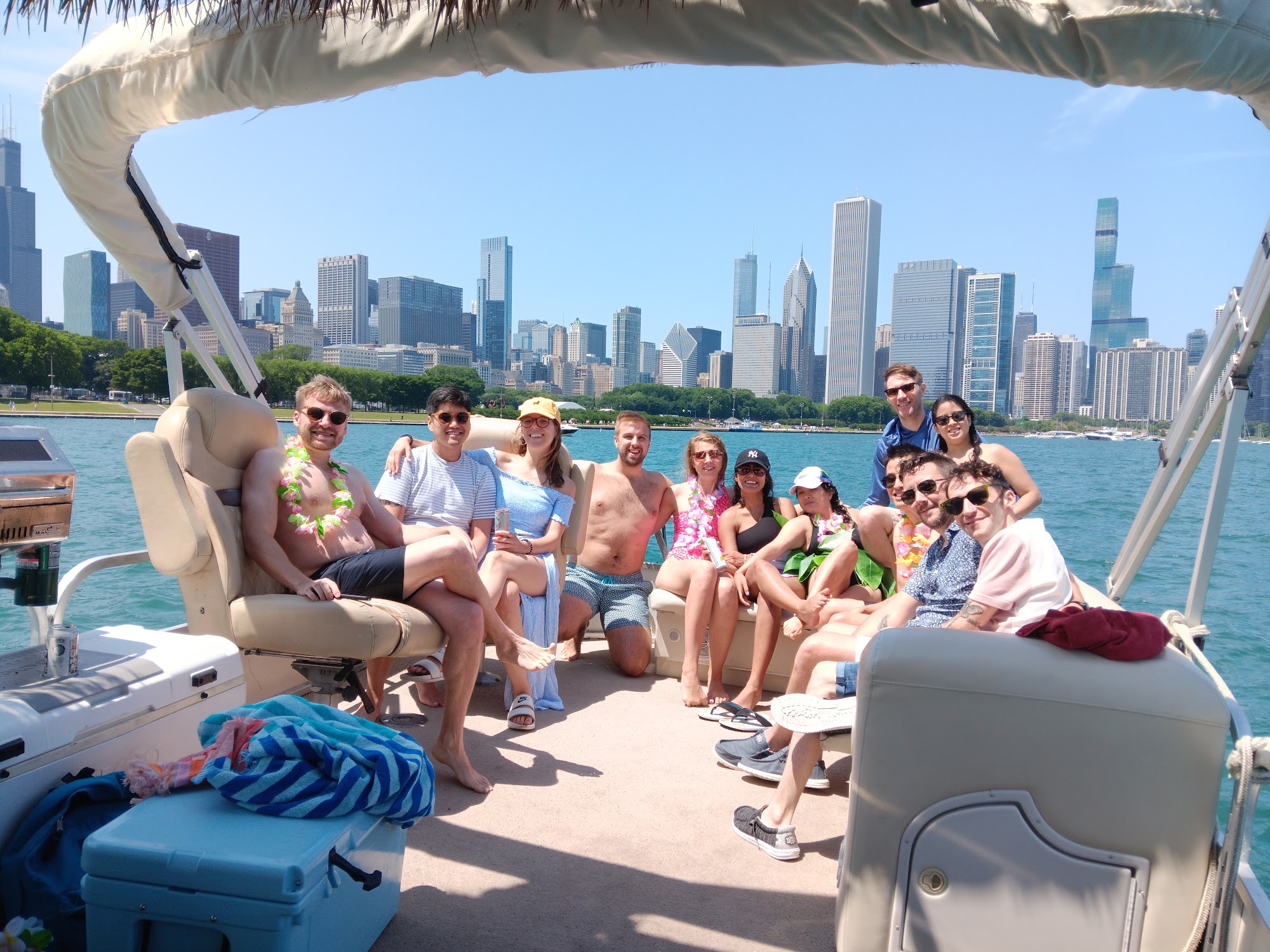 A group of friends relaxing on the pontoon with the Chicago skyline behind them