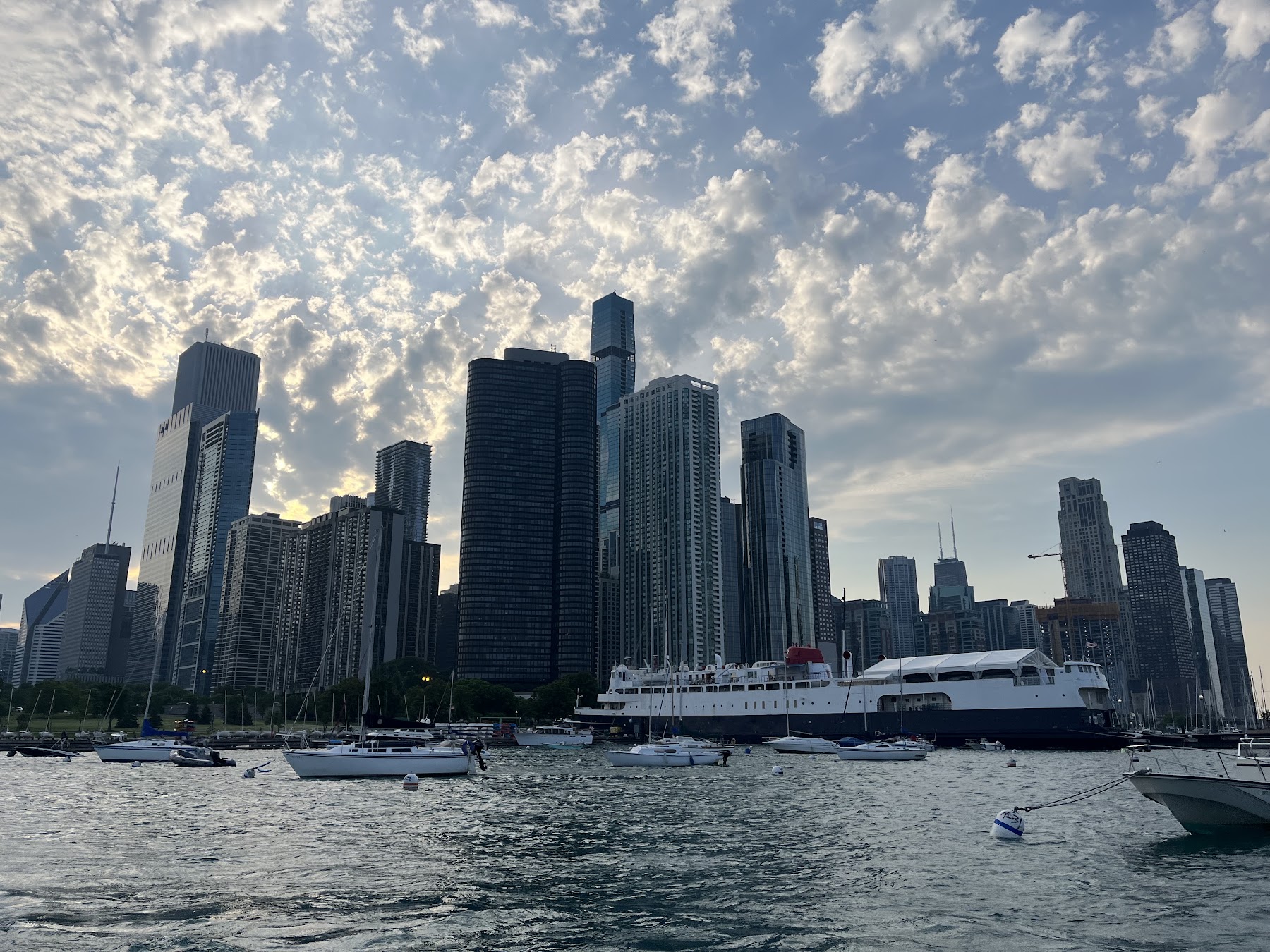 Daytime skyline over the harbor with boats at anchor, photographed by a guest