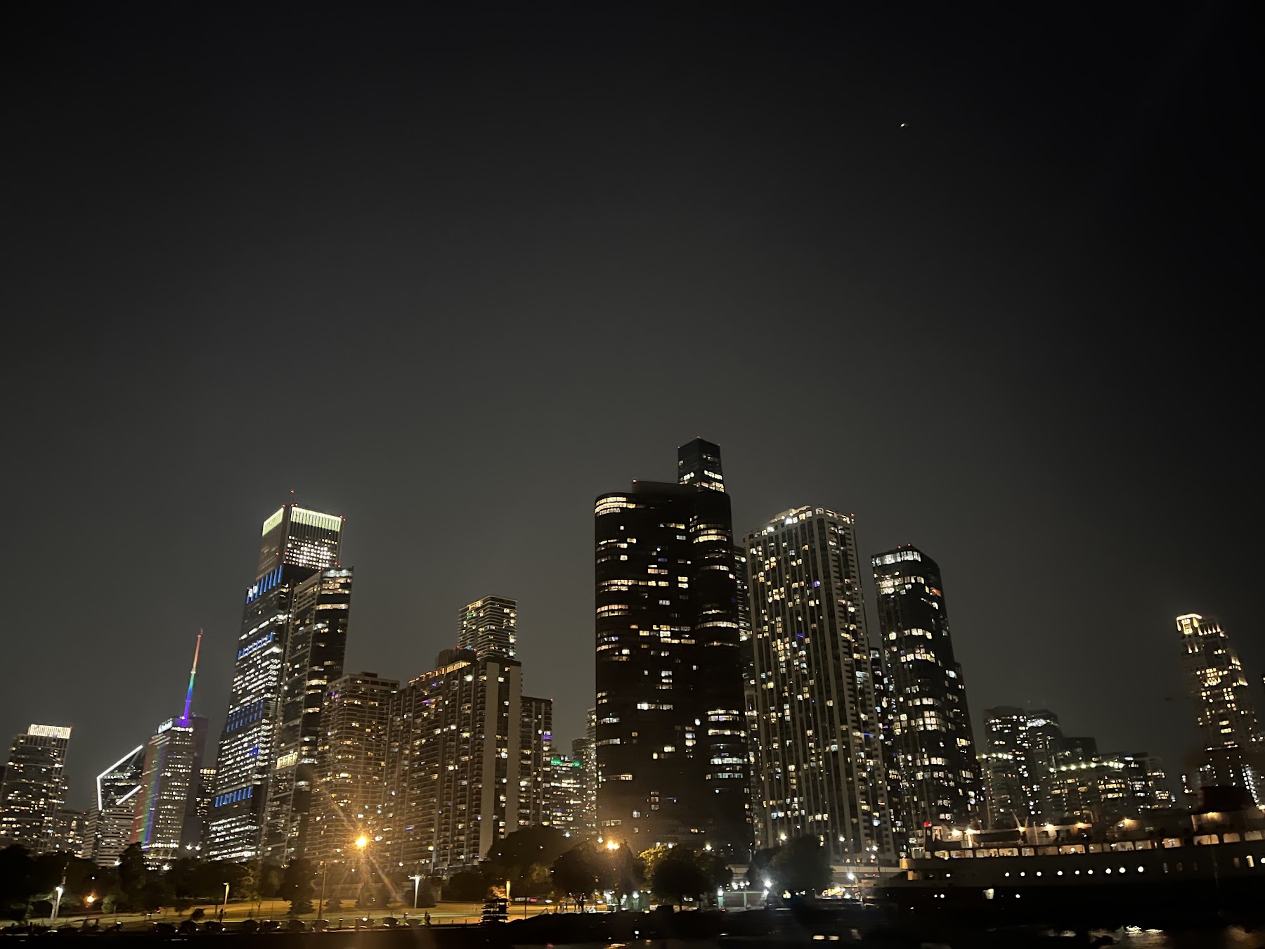 Downtown lights across dark water at night, photographed by a guest