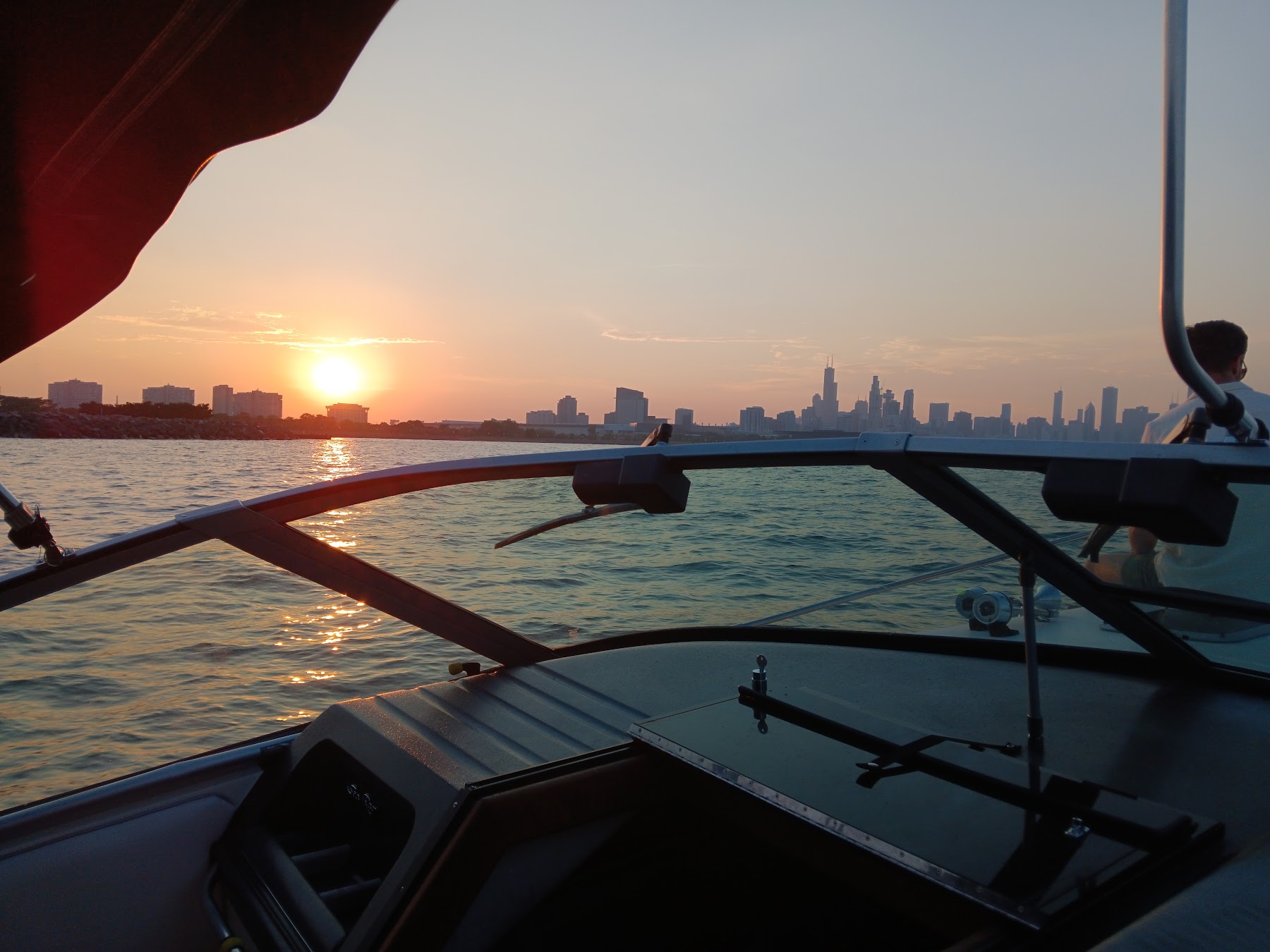 The sun dropping toward the horizon over Lake Michigan, seen from the boat